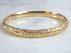 "FOR SALE IS THIS WONDERFUL WOMENS 14k GOLD BRACELET THAT WEIGHS 13.5g AND MEASURES ABOUT 1/4\" WIDE WITH AN OPENING THAT IS 2 5/8\" BY 2 3/8\". PIECE IS UNMARKED BUT HAS BEEN TESTED. ANY OTHER QUESTIONS PLEASE ASK. BE SURE TO CHECK OUT SOME OF MY OTHER GREAT ITEMS UP FOR SALE. THANK YOU. IF THERE ARE ANY ISSUES PLEASE CONTACT US, WE'RE ALWAYS HAPPY TO TRY TO HELP YOU OUT AS BEST AS WE CAN." Anniversary Bangle Bracelet With Shiny Finish, Yellow Gold Bracelet With Shiny Finish For Anniversary, Formal Round Bangle With Hallmark, Wedding Bangle With Shiny Finish, Hallmarked 14k Gold Bracelet, Round Yellow Gold Bracelet Stamped 14k, Oval Hallmarked Bangle For Anniversary, Fine Jewelry Engraved Round Bracelets, 14k Gold Round Chain Bracelet