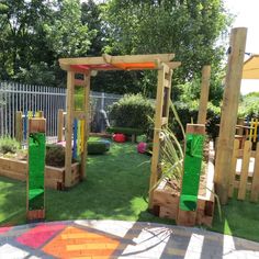 an outdoor play area with grass and wooden structures