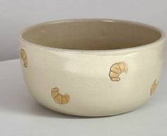 a white bowl with gold designs on it