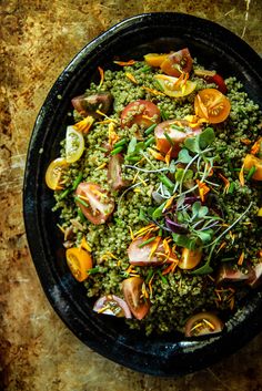 a black bowl filled with food on top of a table