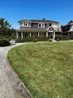 a large house sitting on top of a lush green field