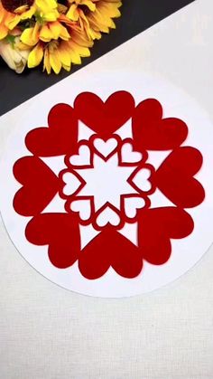 a paper cut out of hearts sitting on top of a table