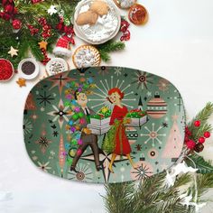 an oval platter decorated with christmas decorations