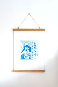 a wooden frame hanging on the wall with a blue and white poster above it that reads, st paul's episcopal