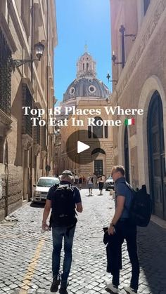 two men walking down an alley way with buildings in the background and text that reads top places where to eat in rome