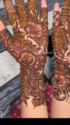 two hands with henna designs on them