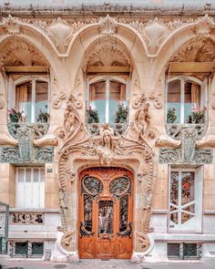 an ornate building with a wooden door and windows