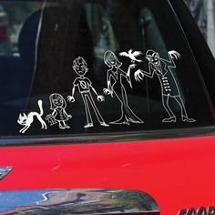 a sticker on the side of a red car with an image of people and a cat