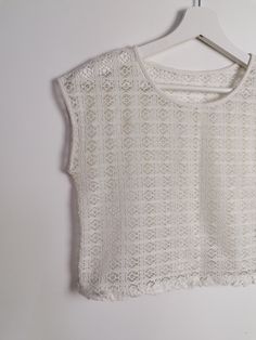 Beautiful off-white sheer crochet knit crop top, fringed hem/ Excellent vintage condition. Would fit size XS. Model wears size 8-10 UK, S-M US, is 160 cm tall and weighs 54 kg. All of our items are freshly laundered with quality detergents and fabric softeners, absolutely ready to wear the moment you receive them! Keep in mind, this item is vintage and subtle signs of passing time may be present, adding to its character and making it even more worthy of your love. For more info, additional photo White Cropped Lace Top With Lace Trim, Short Sleeve Open Knit Crochet Top, Lace Crochet Open Knit Top With Short Sleeves, Lace Crochet Top With Short Sleeves, Cropped Lace Top With Crochet Details, Cream Open Knit Lace Tops, White Open Knit Lace Top, White Lace Tops With Pointelle Knit, White Lace Pointelle Knit Top