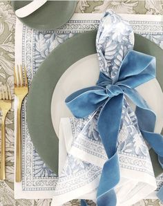 a place setting with blue and white napkins