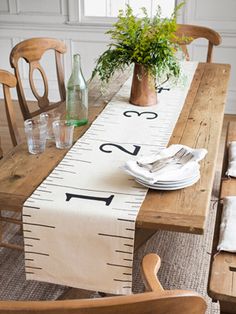 a wooden table topped with a ruler runner