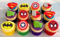 there are many cupcakes that have different designs on them, including batman and spider - man