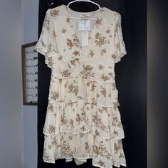 Medium Length Dress Cream Dress With Brown Design Large Feels Like It Could Actually Be A Medium Waist Not Stretchy Casual Beige Floral Dress With Ruffles, Beige Tiered Dress For Spring, Beige Tiered Dresses For Spring, Cream Tiered Dress For Day Out, Casual Beige V-neck Floral Dress, Beige Tiered Sundress, Cream Ruffle Hem Dress For Day Out, Flowy Cream Mini Dress With Ruffle Hem, Cream Tiered Fitted Mini Dress