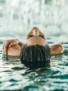 a woman floating in the water with her eyes closed