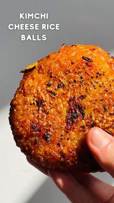 a hand holding up a piece of food with the words kimchi cheese rice balls on it