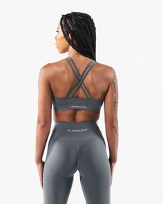 HIGHLIGHTS. Seamless construction Rib panel for support Low to Medium impact Moisture-wicking breathable fabric Flattering scoop neckline FIT SUGGESTION. This item runs true to Alphalete's standard seamless fit.. If you are between sizes, we recommend sizing up.. Model is 5’2”/157.5cm, wearing a size XS with a 34.5”/87.6cm bust. MATERIALS AND WASHING DIRECTIONS. 51% Polyamide, 38% Polyester, 11% Elastane. We recommend washing inside-out on a cold setting. Hang to dry DESCRIPTION With the beloved Gray Seamless Nylon Activewear, Gray Compressive Nylon Activewear, Gray Compression Seamless Activewear, Gray Compression Activewear With Seamless Construction, Compressive Gray Activewear With Built-in Padding, Gray Compression Racerback Activewear, Gray Stretch Seamless Sports Bra, Gray Activewear With Built-in Padding And High Stretch, Gray Compression Sports Bra In Nylon