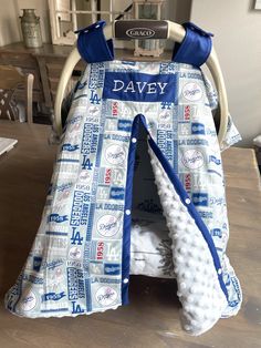 a baby's car seat cover that has been made to look like a football helmet