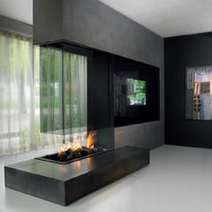 an empty room with a fire place in the center