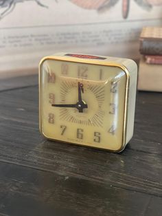 an alarm clock sitting on top of a wooden table