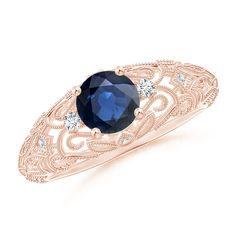 an oval blue sapphire and diamond ring in rose gold with white diamonds on the sides