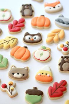 many different decorated cookies on a white surface