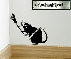 a black and white photo of a wall with a sticker of a monkey holding a broom