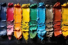 an array of different colors of paint on a black surface