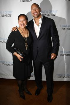 a man and woman standing next to each other in front of a white wall with the words have a dream foundation on it