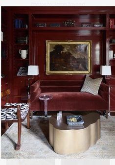 a living room with red walls and furniture