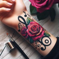 a woman's arm with roses on it and scissors in the middle, next to a pink rose