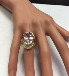 16.18 Carats Exquisite Natural Pink Kunzite and Diamond 14K Solid Rose Gold Ring Appraised Value 8,900.00 Total Natural Oval Shaped Kunzite Weights: 15.90 Carats (VS) Kunzite Measures: 18.36 x 13.52mm Natural Round Diamonds Weight: .28 Carats (color F-G / Clarity VS2) Ring total weight: 10.7 grams Disclaimer: all weights, measurements and colors are approximate and may vary slightly from the listed dimensions or as seen in the image. All pictures are magnified to show the smallest of details. Pl Formal Morganite Diamond Ring, Formal Morganite Diamond Ring Fine Jewelry, Formal Morganite Diamond Ring In Fine Jewelry Style, Formal Morganite Diamond Ring With Accents, Formal Morganite Diamond Ring With Diamond Accents, Exquisite Formal Morganite Ring, Formal Morganite Diamond Ring With Center Stone, Heirloom Morganite Diamond Ring For Formal Occasions, Elegant Morganite Rings For Formal Events