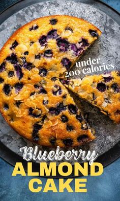 a blueberry almond cake on a plate with the words under 200 calories above it