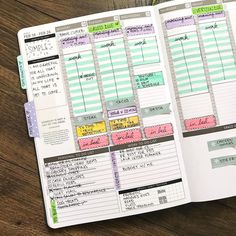 an open planner with notes and stickers on the pages, sitting on top of a wooden table