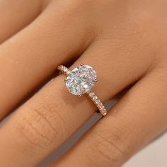 a woman's hand with a diamond ring on top of her finger and an engagement band