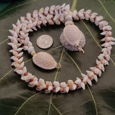 This necklace is a exquisite Kauai Laiki shell lei. Not only will this necklace maintain it's integrity and luster, it will continue to gain in value exponentially. The Laiki shells are only found on a few select beaches on Kauai and on the forbidden Island of Niihau. I collect mine on the north shores of the garden island of Kauai and sort each one by size, color, and quality. I then hand drill the holes in them in precisely the right place for this intricate and difficult weave. This necklace Hand-strung Strand Jewelry As Gift, Spiritual White Shell Necklace, White Shell Necklaces With Lobster Clasp, Shell Necklace For Jewelry Making, White Shell-shaped Necklaces For Jewelry Making, Single Strand Shell Necklace For Gift, Shell Single Strand Necklace For Gift, Single Strand Shell Necklace For Gifts, Single Strand Shell Necklace, Ideal For Gifts