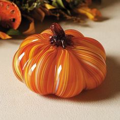 a glass pumpkin sitting on top of a table