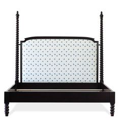 a black bed frame with blue and white polka dots