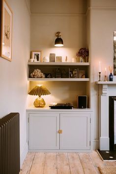 a living room filled with furniture and a fire place next to a wall mounted heater