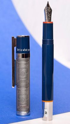 a fountain pen sitting next to a metal container