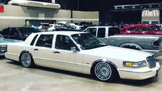 several old cars are parked in a garage