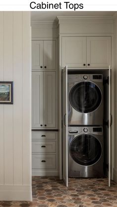 two washers and dryer in a white kitchen