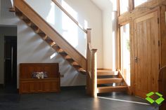 an empty room with stairs and wooden furniture