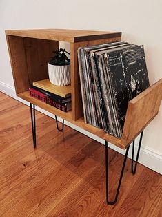 a wooden shelf with some vinyl records on it