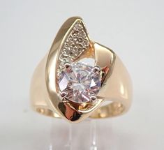 a gold ring with a diamond in the center