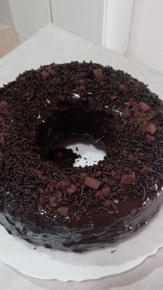 a chocolate cake sitting on top of a white plate