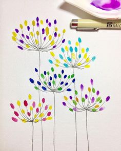 a drawing of colorful flowers on white paper