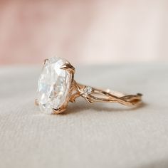 a close up of a diamond ring on a table