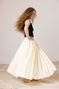 High waisted, voluminous tea length skirt in a beautiful ivory moire fabric with side inseam pockets. Lined in tulle for extra puff. Elastic at back waist for comfort. Invisible zipper closure. Elegant Cream Gathered Skirt, White Gathered Skirt For Evening, Elegant Petticoat For Debutante Ball, Cream Gathered Full Skirt, Cream Full Gathered Skirt, Voluminous Pleated Full Petticoat, Elegant Full Skirt Petticoat For Prom, Cream Full Tulle Skirt, Elegant Flowy Skirt Petticoat For Evening