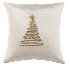 a white pillow with a gold christmas tree embroidered on it