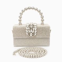 Shaped in a timeless box form, the Anisha Rhinestones Handbag exudes an irresistible allure. However, what truly distinguishes it is its one-of-a-kind handle—a statement piece designed to captivate attention and elevate your ensemble to new heights. With its generous interior, this bag offers ample space for all your essentials, seamlessly blending practicality with undeniable style. Now available in gold and silver. Chic Evening Crystal Bags, Glamorous Silver Top Handle Bag, Glamorous Silver Bag With Detachable Handle, Chic Silver Bags With Rhinestones, Chic Embellished Crystal Bag, Glamorous Crystal Embellished Bags, Chic Crystal Bags For Events, Elegant Crystal Bags With Rhinestones, Luxury Silver Box Bag